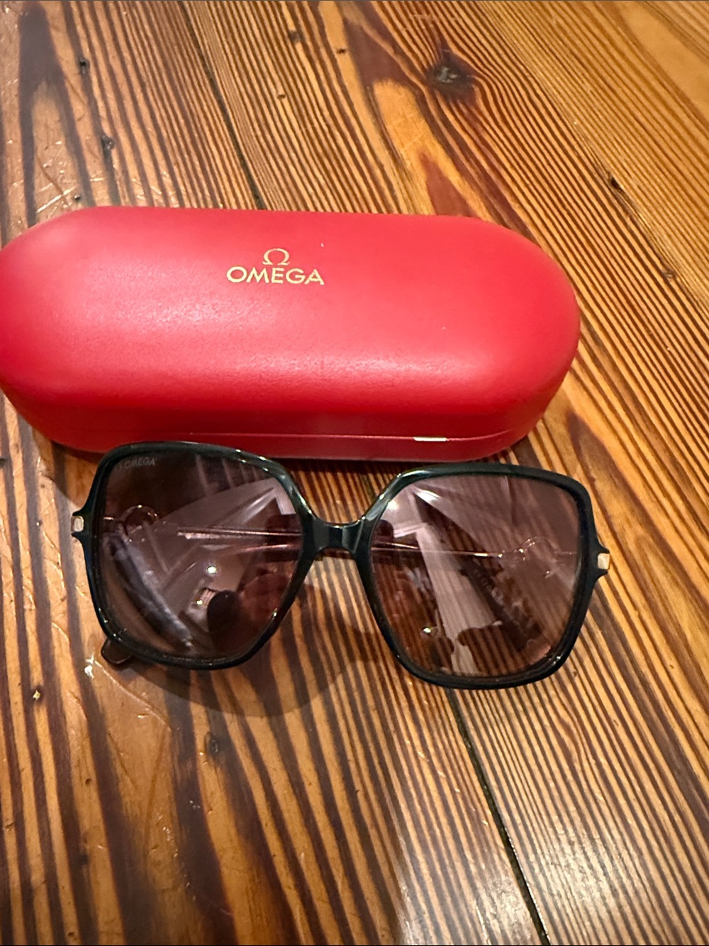 Omega Women's Black Sunglasses with Gradient Brown Lenses